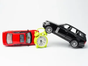 two toy cars next to a clock